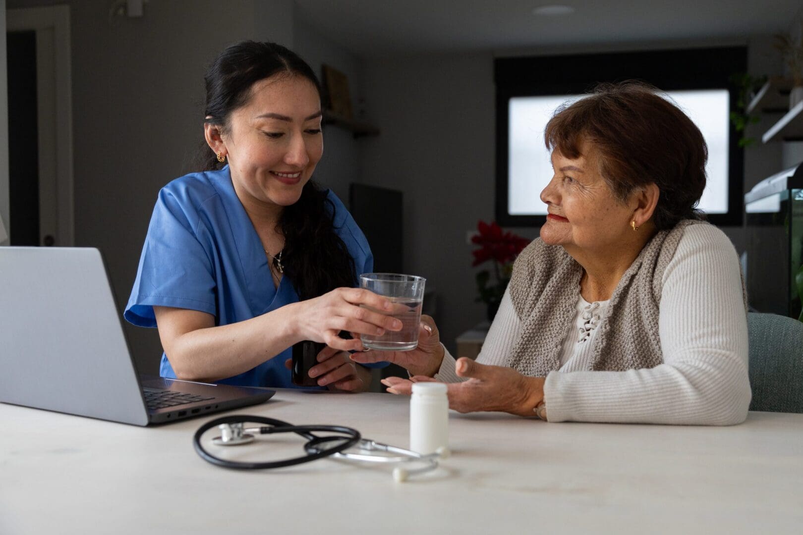 Healthcare professional helping elderly patient